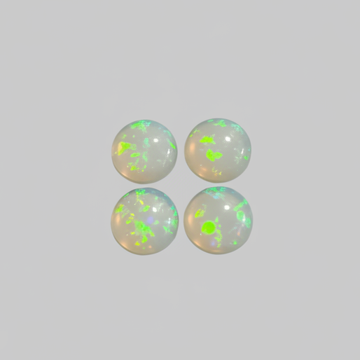 Four round white opal cabochons with vibrant green and multicolor flashes, arranged in a 2x2 grid on a plain light gray background.