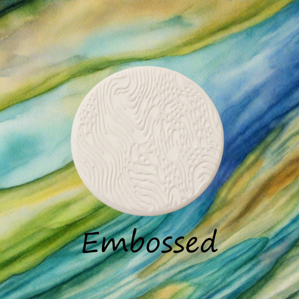 A pattern debossed in clay using a patterned embossed texture mat.