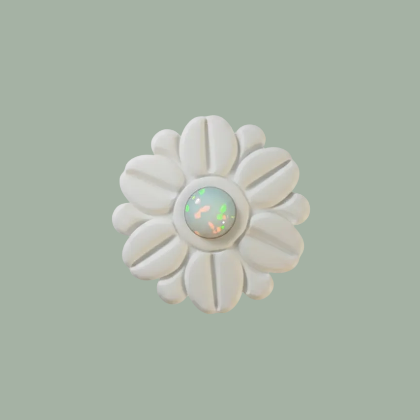 A round white clay raised flower design and a small iridescent opal-centre, shown on a plain white background.