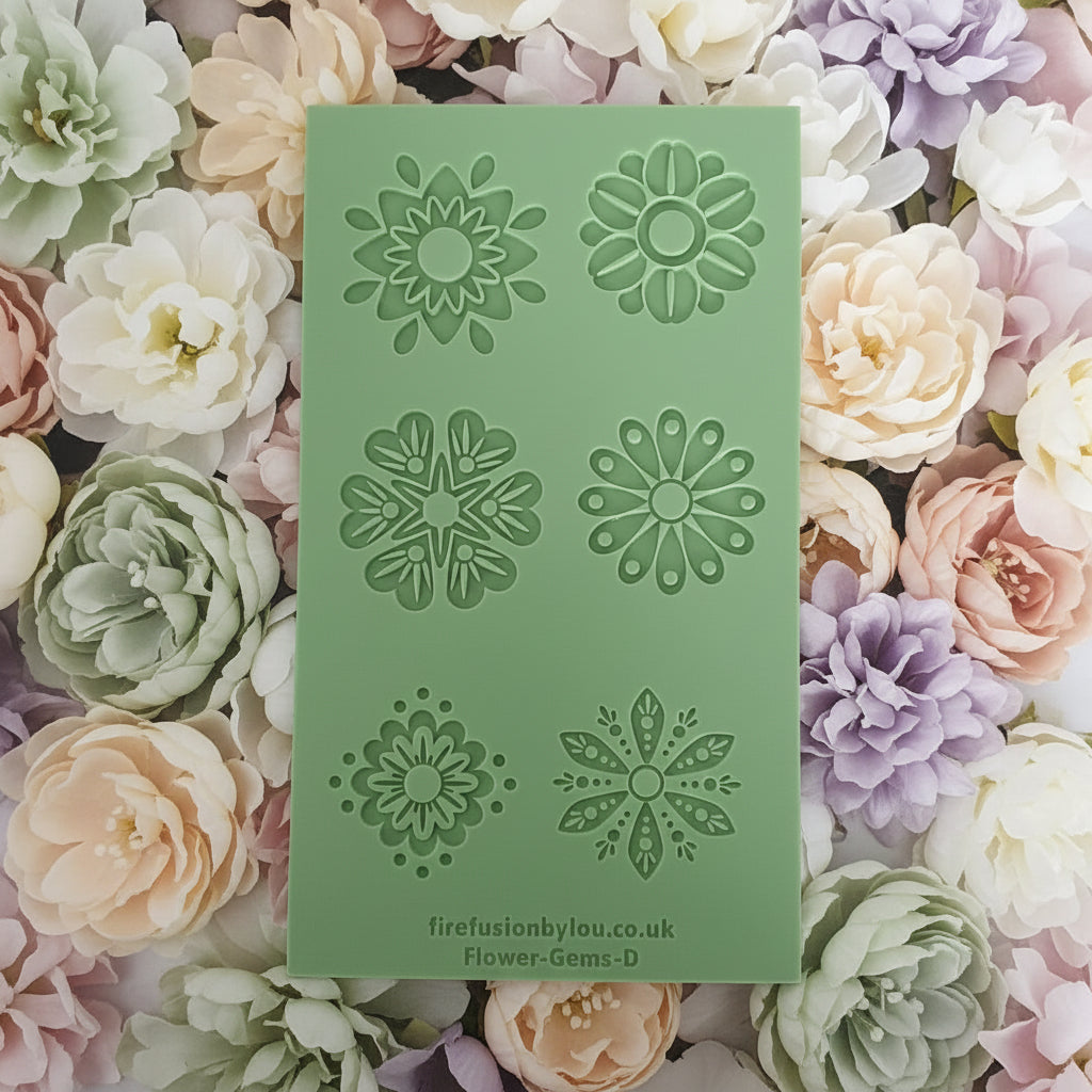 A mint green texture with six embossed floral mandala designs, placed on top of a bed of pastel flowers in white, pink, peach, and lavender.