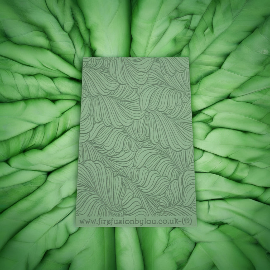 A 95 x 55 mm debossed texture mat with  curly leaves. Use to make a embossed impression on metal clay and polymer clay.