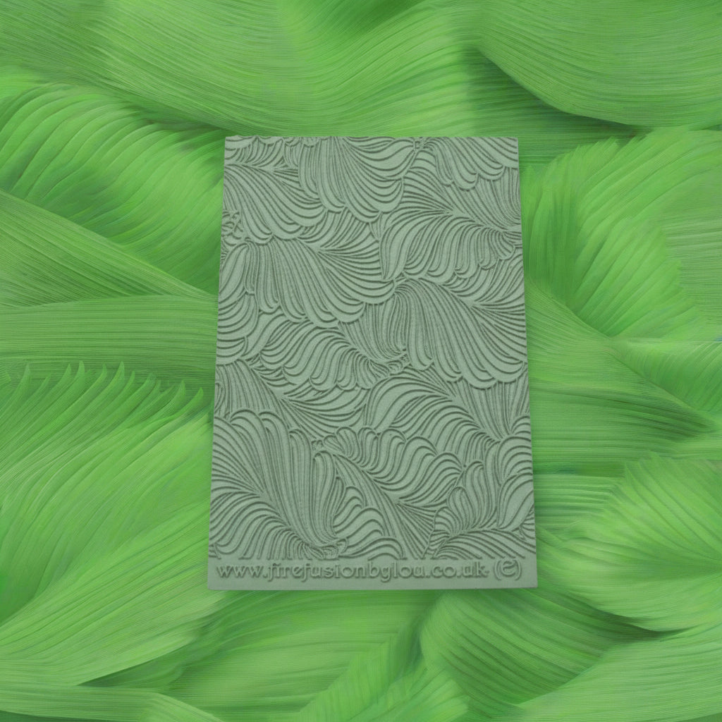 A 95 x 55 mm embossed texture mat with  curly leaves. Use to make a embossed impression on metal clay and polymer clay.