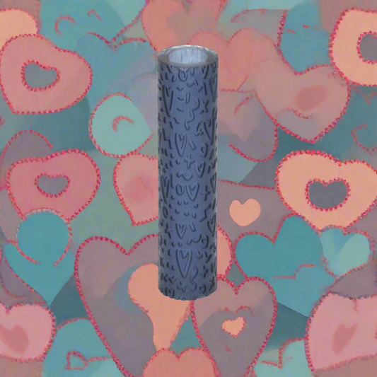 A textured roller for crafting with clay, displayed against a background of decorative hearts.