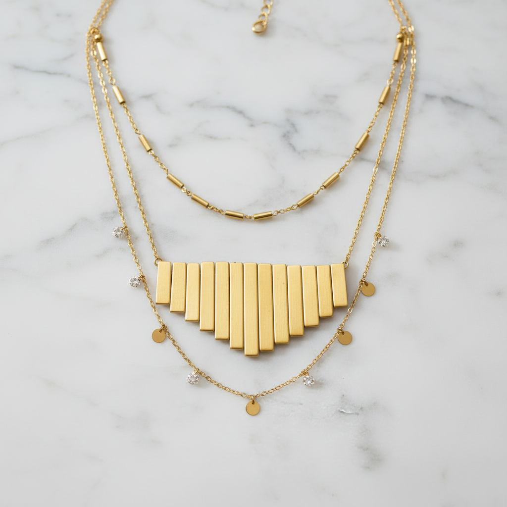"Metallic gold graduated fan beads arranged as pendant design showing cascading Art Deco style necklace focal piece"