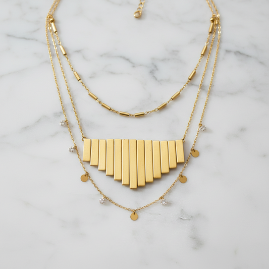 "Metallic gold graduated fan beads arranged as pendant design showing cascading Art Deco style necklace focal piece"