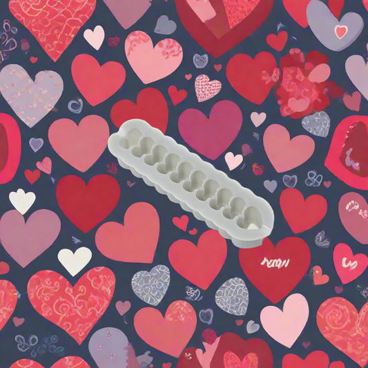 A resin cutter designed for cutting materials such as metal clay or polymer clay, with a pattern of hearts in a row.