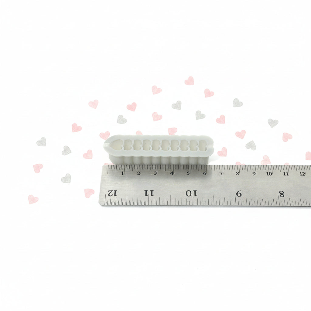 Small hearts with a ruler for scale on a white background