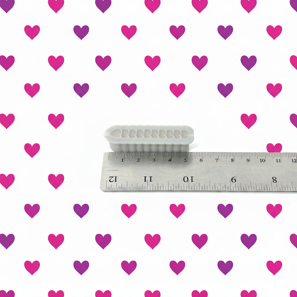 Small hearts on a white background with pink and purple hearts.
