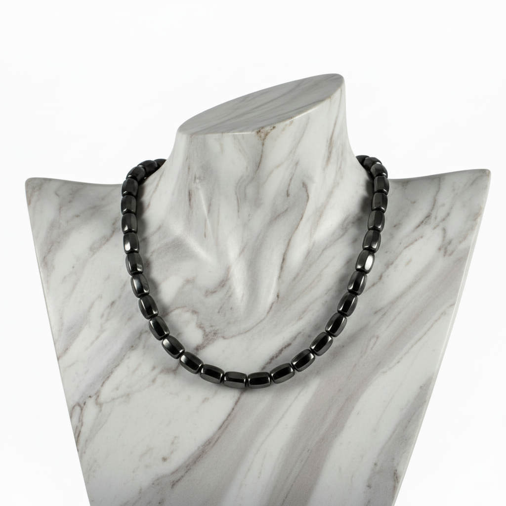 "Hematite barrel beads 9x8mm strand displayed on jewellery bust showing eight sided faceted metallic grey gemstone necklace"
