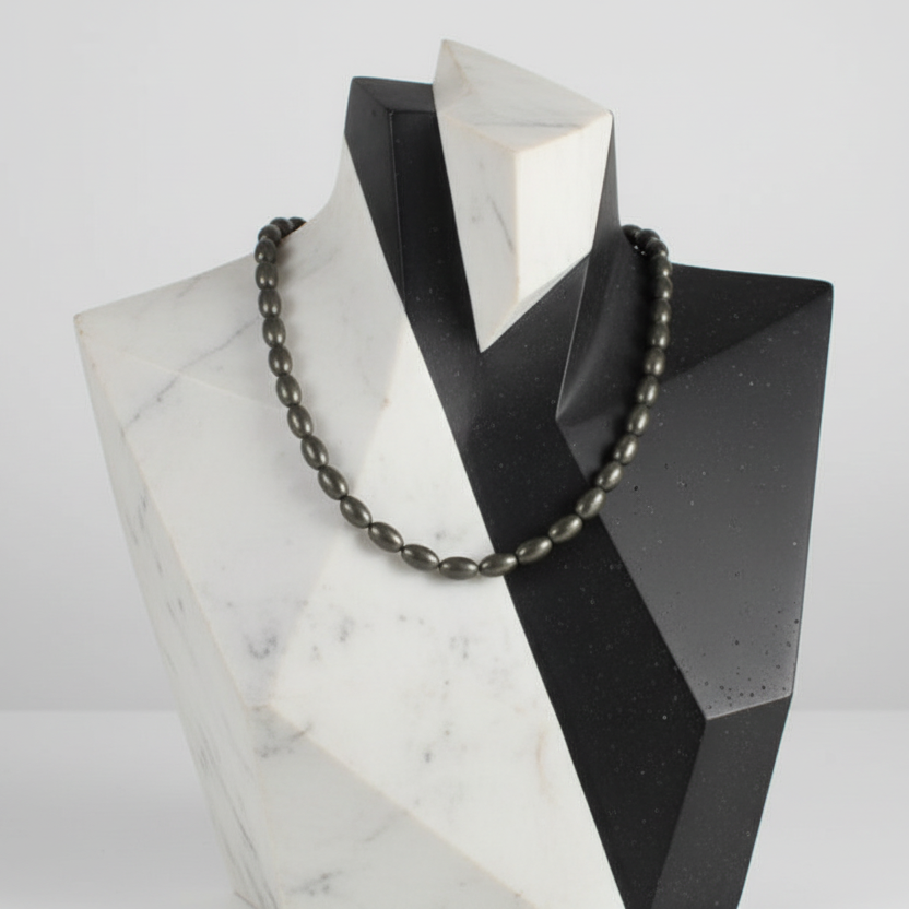 "Hematite electroplated gold rice beads 9x5mm displayed on jewellery bust showing elegant drape"