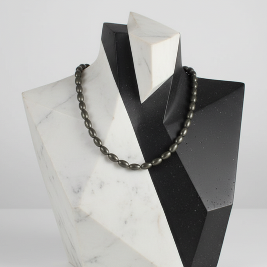 "Hematite electroplated gold rice beads 9x5mm displayed on jewellery bust showing elegant drape"