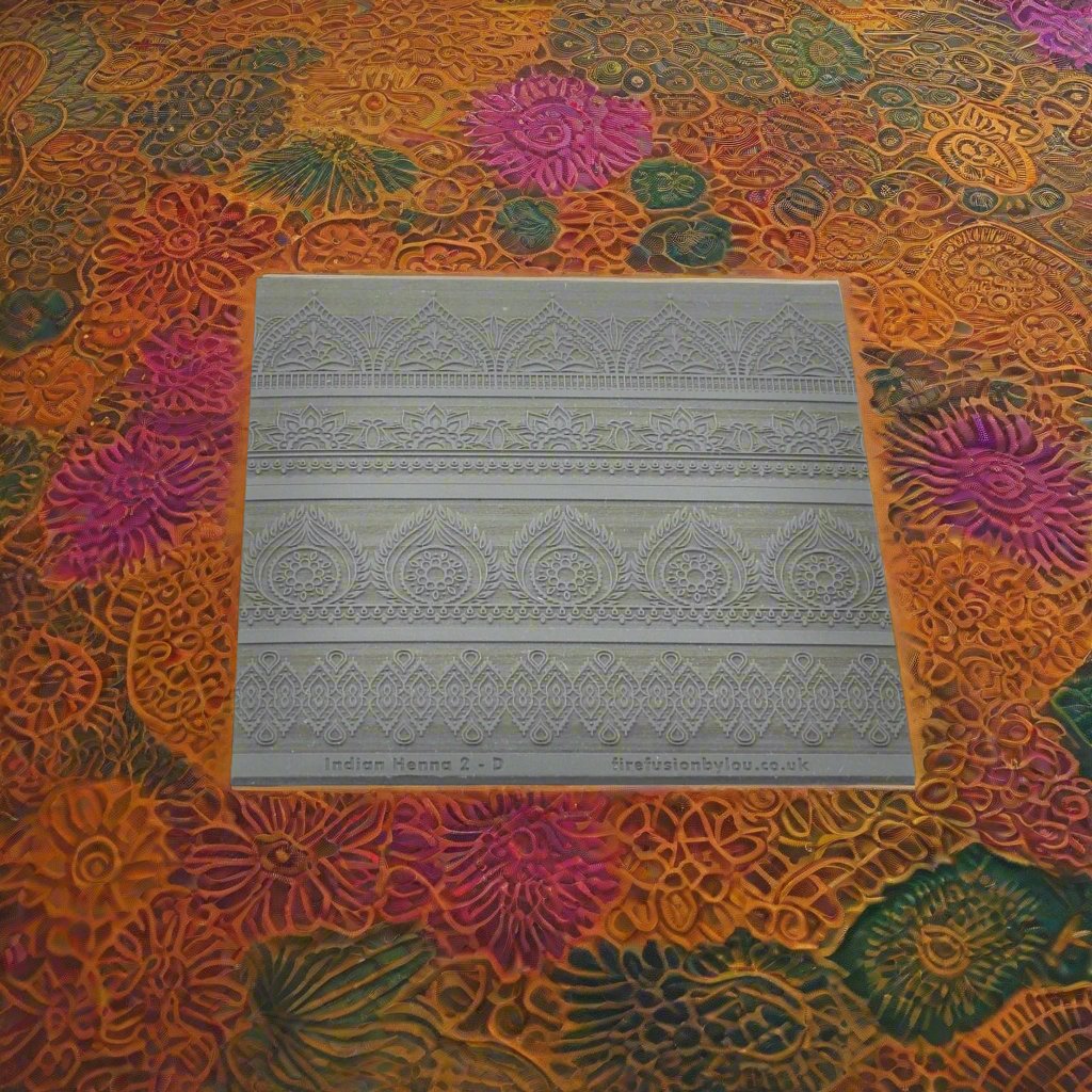A Indian henna embossed texture mat in grey material. This texture mat will give you a debossed effect on metal clay or polymer clay.