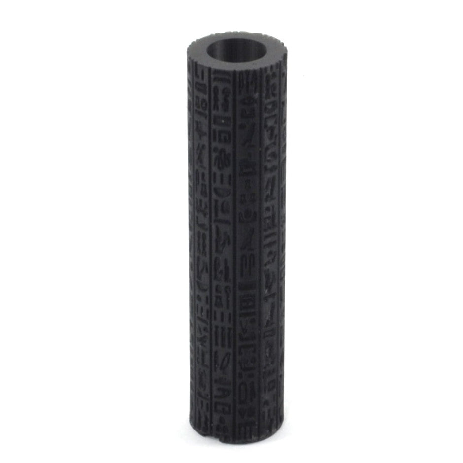 Black cylindrical object with textured surface on a white background
