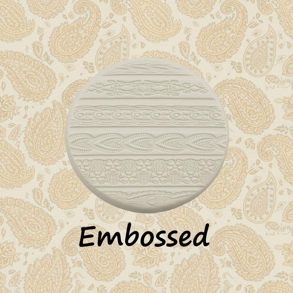 A pattern debossed in clay using an Indian henna embossed texture mat in grey material. This will give you an idea of what it will look like on metal clay or polymer clay.