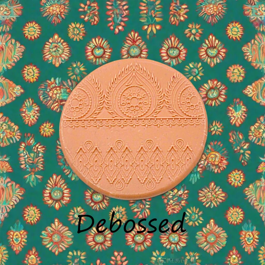 A pattern embossed in silly putty Using an Indian henna debossed texture mat in grey material. This will give you an idea of what it will look like on metal clay or polymer clay.