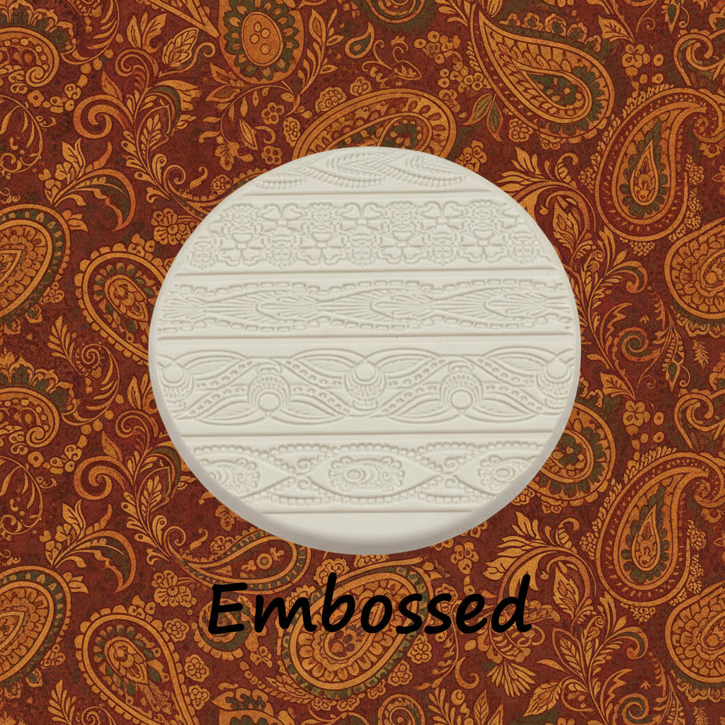 A pattern debossed in clay using an Indian henna embossed texture mat.