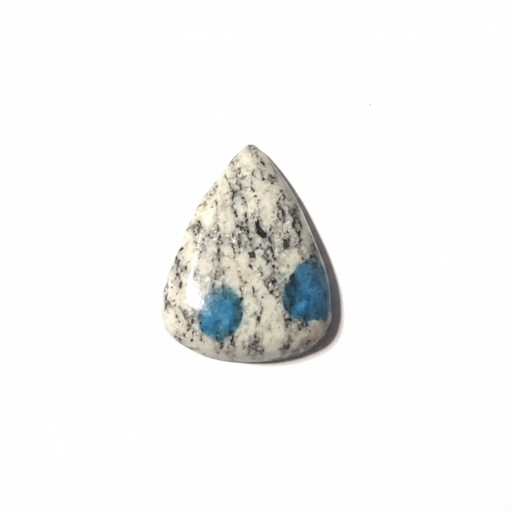 Teardrop-shaped stone with blue spots on a white background