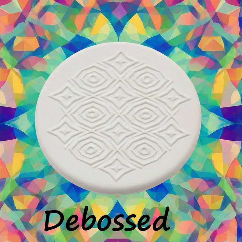 A pattern embossed in clay using a patterned debossed texture mat in grey material. 