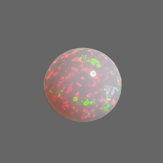 A spherical translucent dome-shaped opal with a frosted pink body and glowing red and green internal or surface illumination, shown against a solid dark grey background.