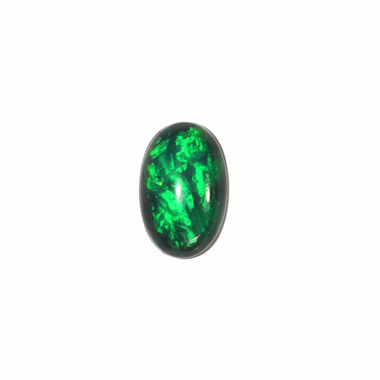 A small oval cabochon gemstone with a black base and vibrant green matrix, shown on a plain light gray background.