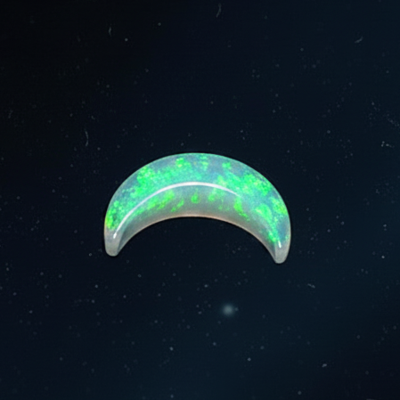 A crescent-shaped white opal gemstone with vibrant green and blue flashes, displayed against a dark starry background.