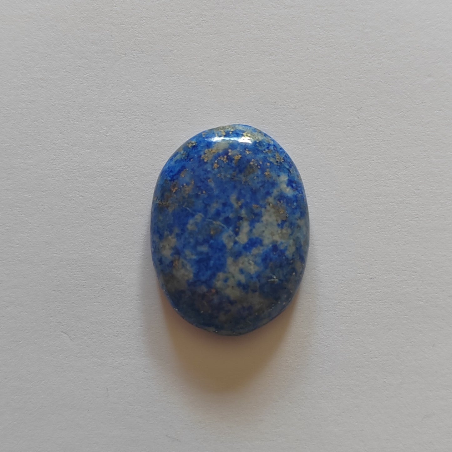 Blue and gray speckled stone on a light gray background