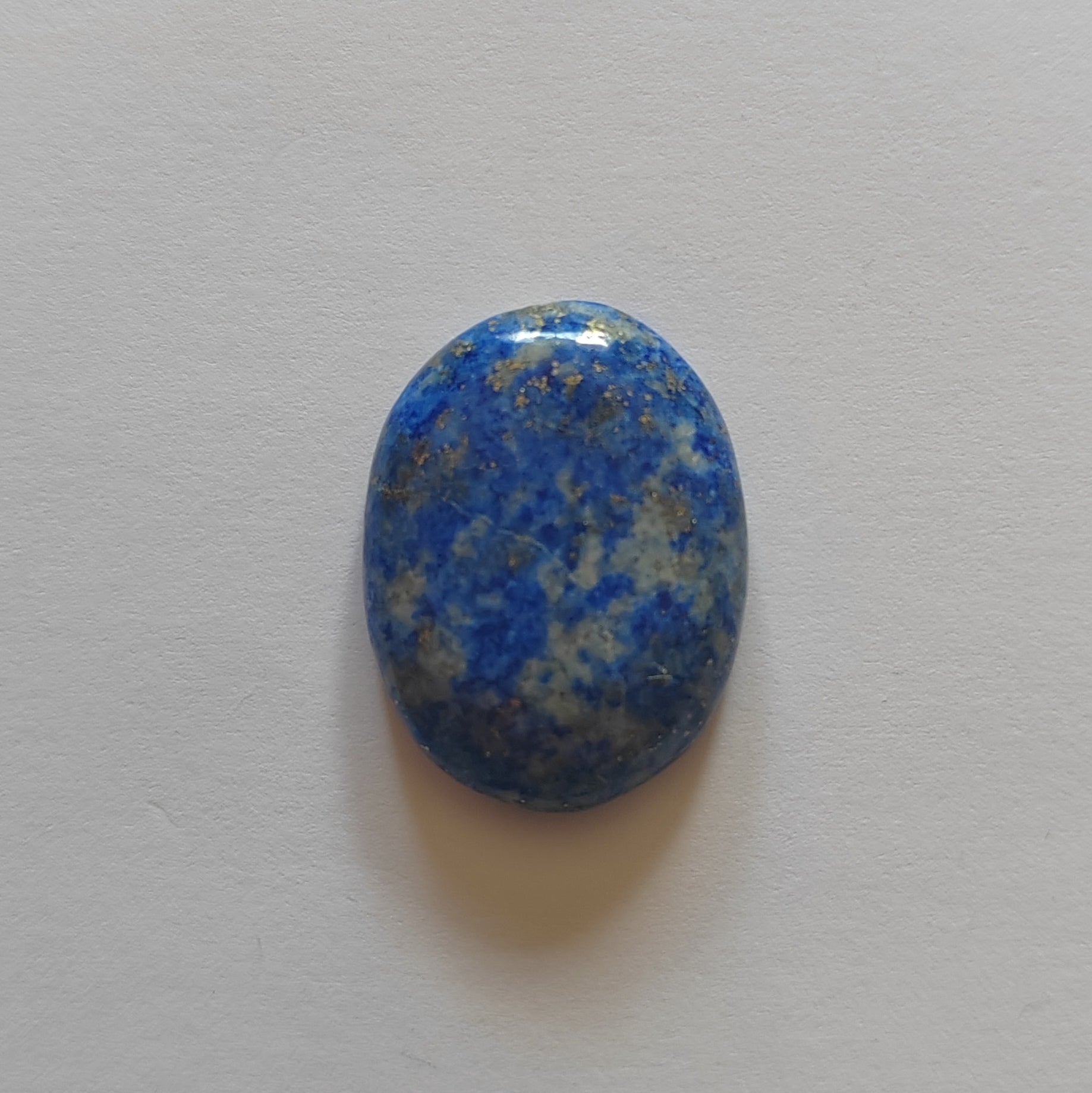 Blue and gray speckled stone on a light gray background