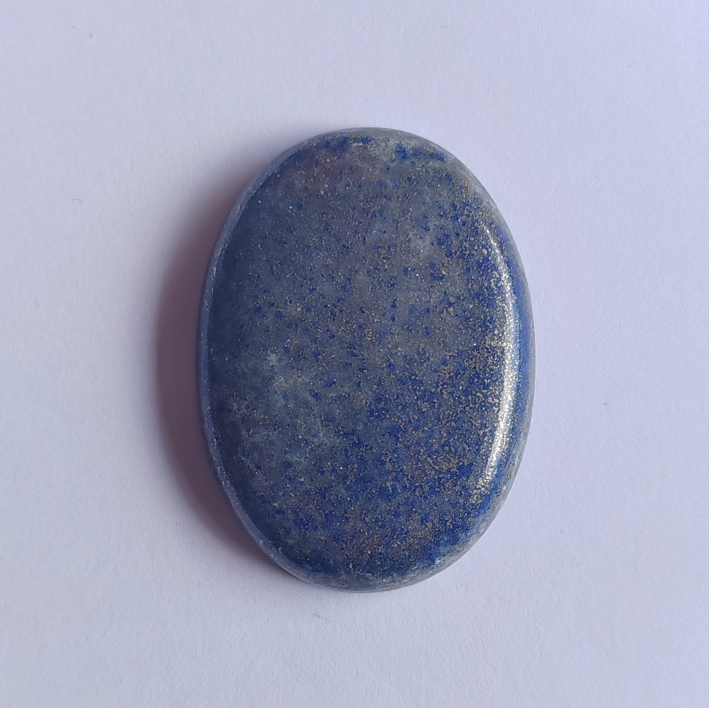 Oval-shaped blue stone on a white background