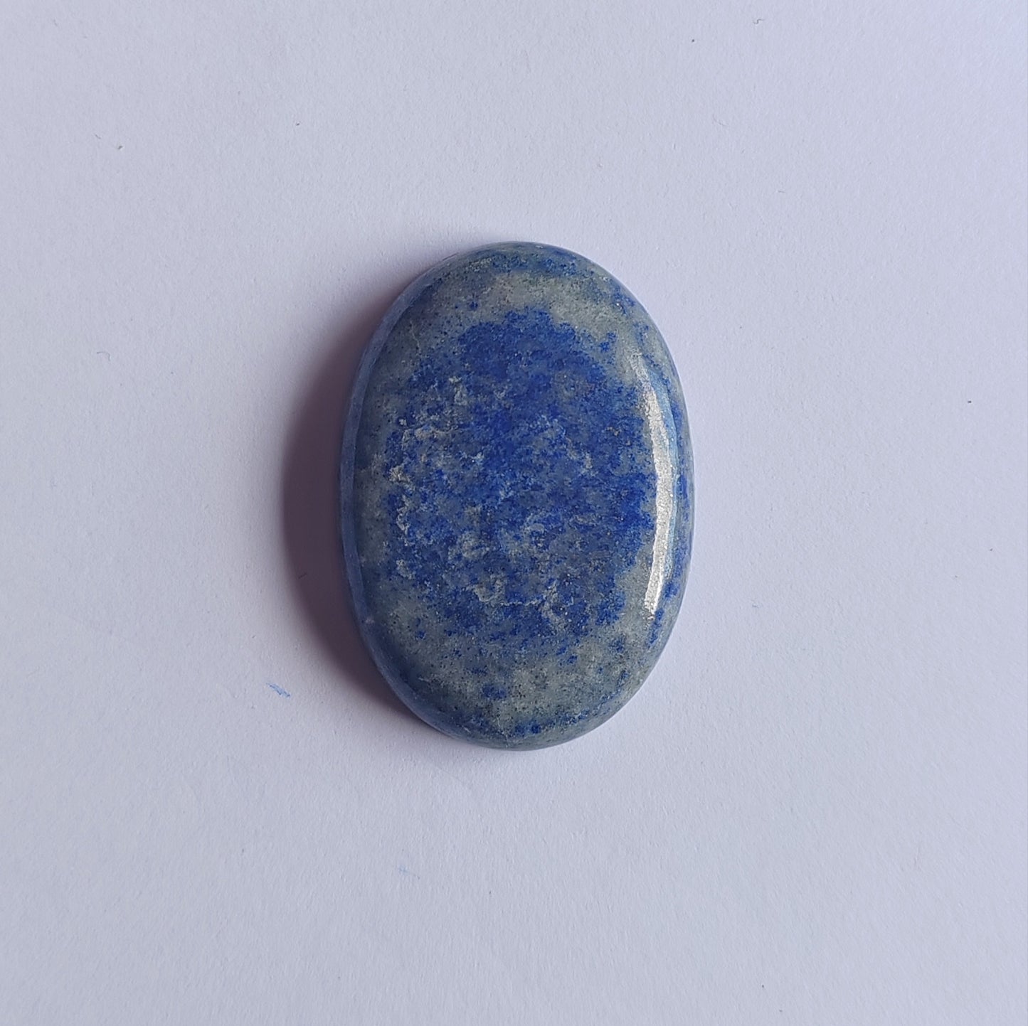 Oval-shaped blue stone on a white background