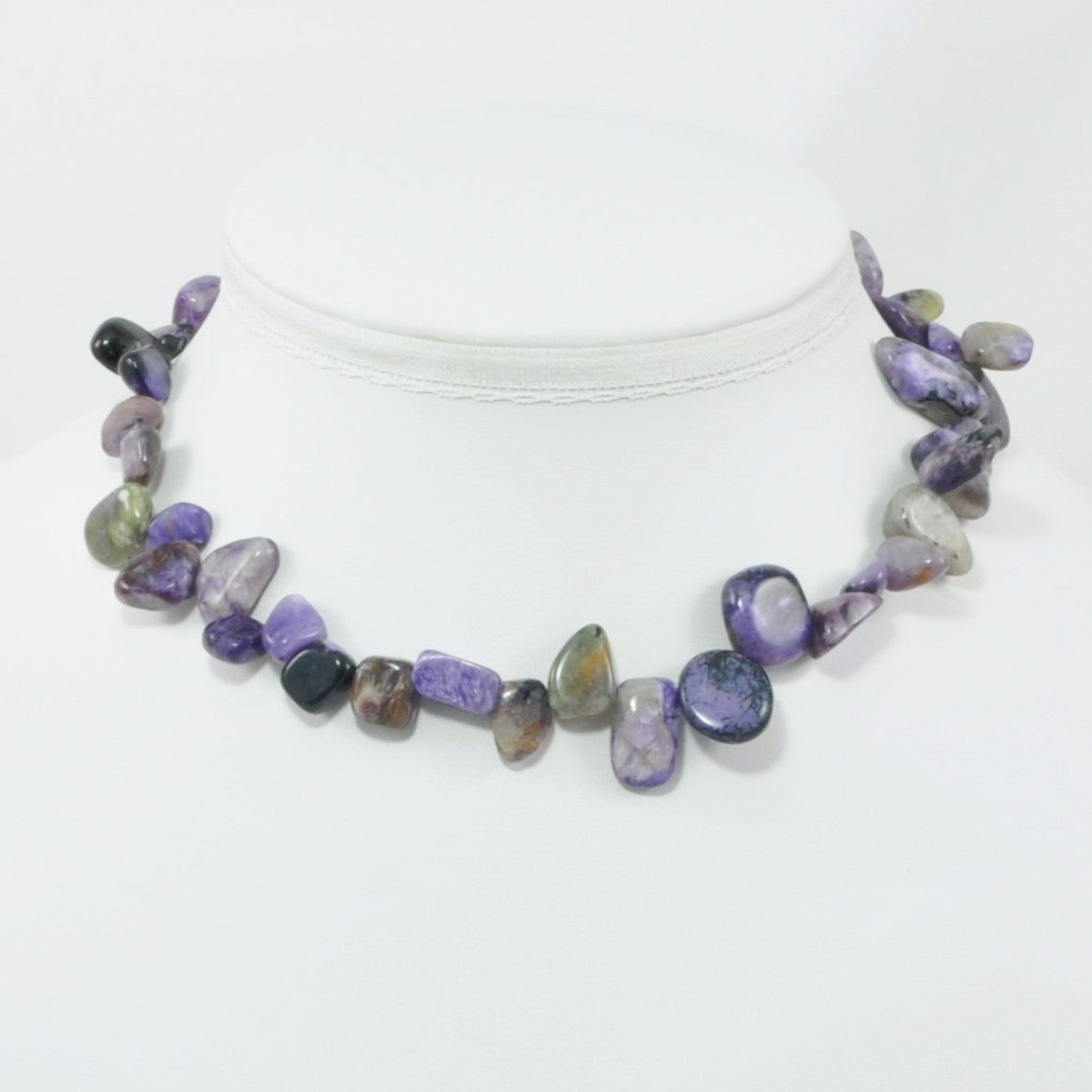 Necklace with multicolored stones on a white background
