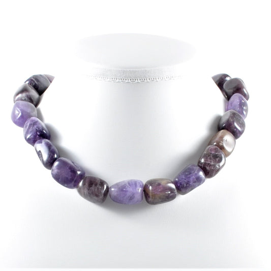 Purple beaded necklace on a white background
