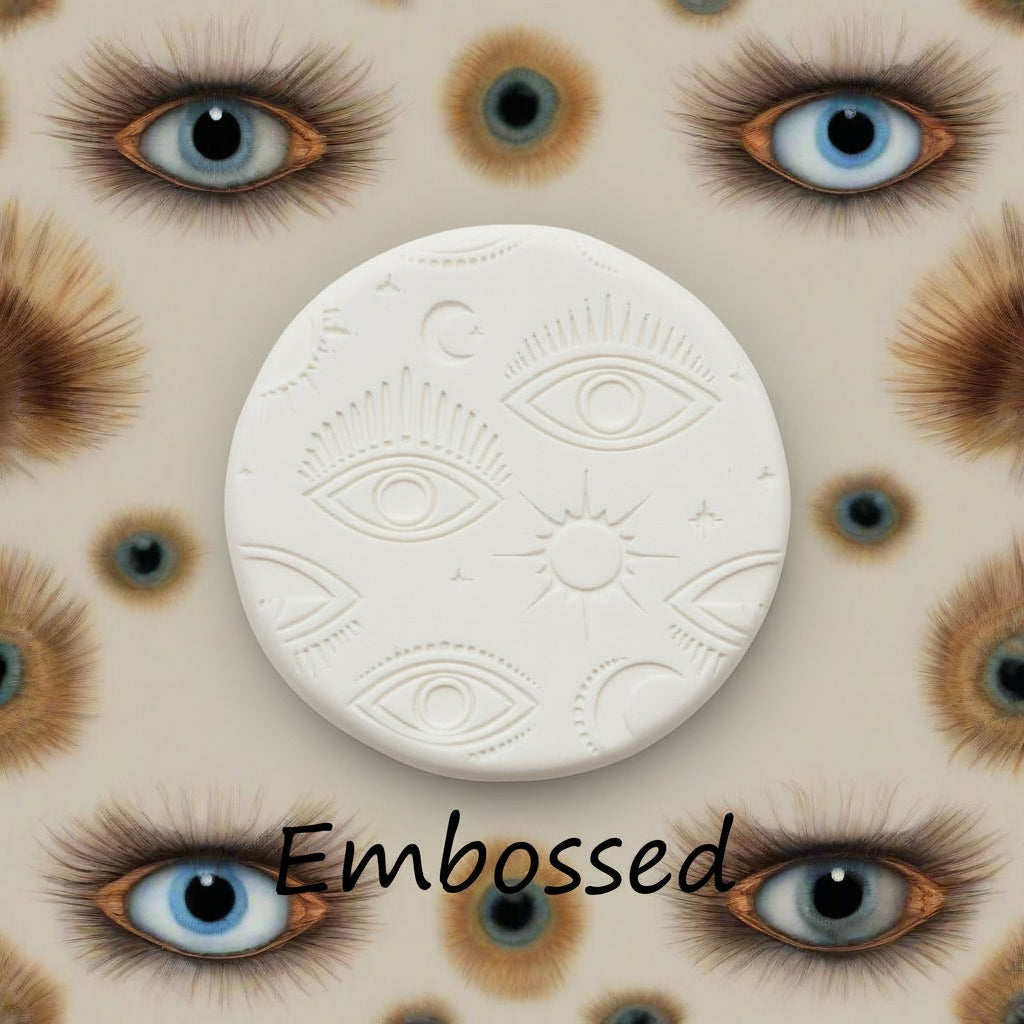 A mystical eye pattern debossed in clay Using a patterned embossed texture mat in grey material. This will give you an idea of what it will look like on metal clay or polymer clay.