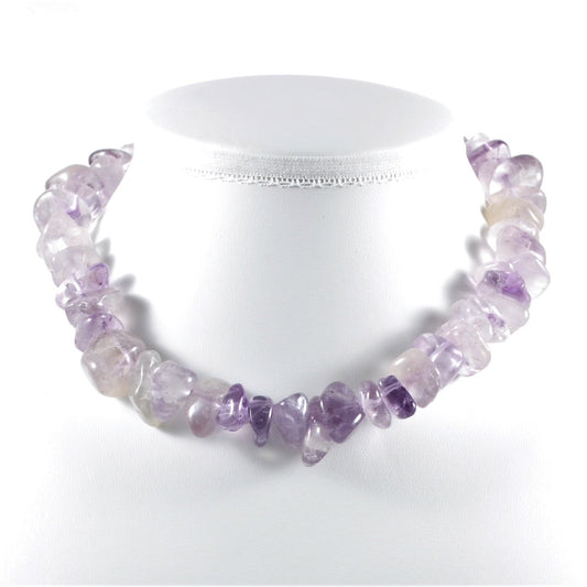 Necklace with purple and clear gemstones on a white background