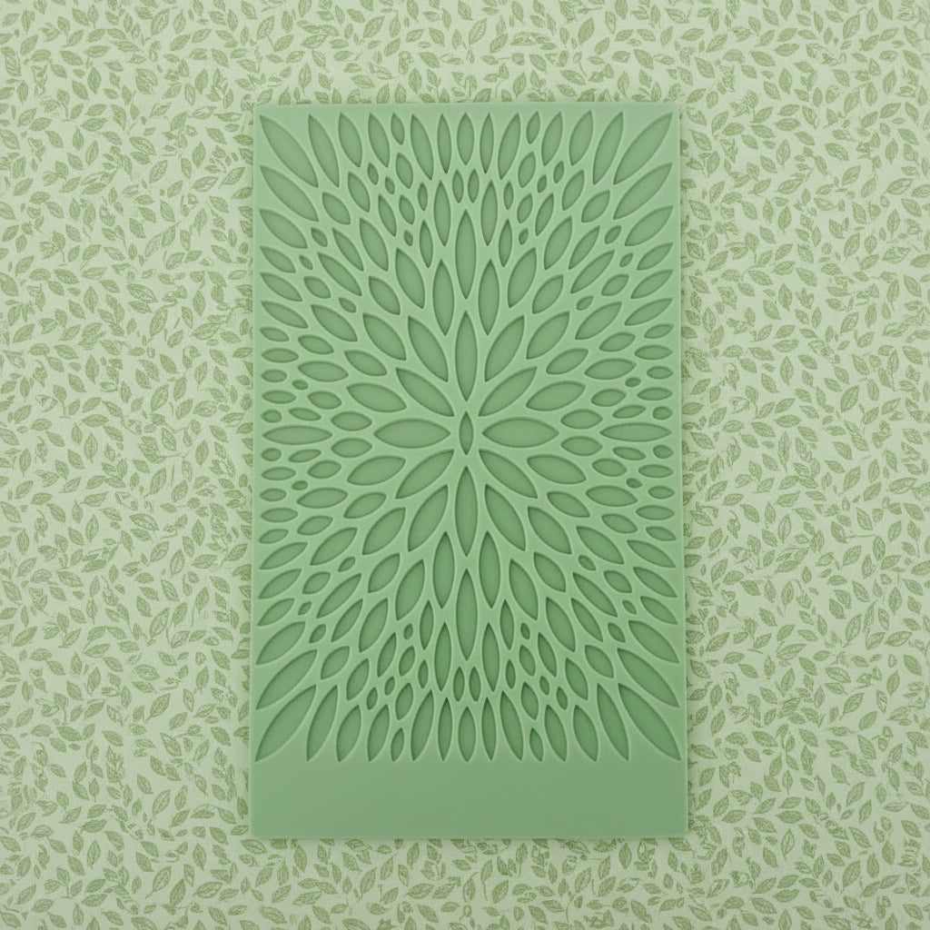 A rectangular mat with a radial, leaf-like cut out pattern.
