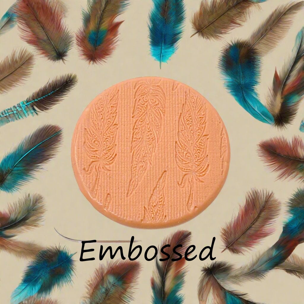 An intricate tribal feather pattern debossed in silly putty Using a patterned debossed texture mat in grey material. This will give you an idea of what it will look like on metal clay or polymer clay.
