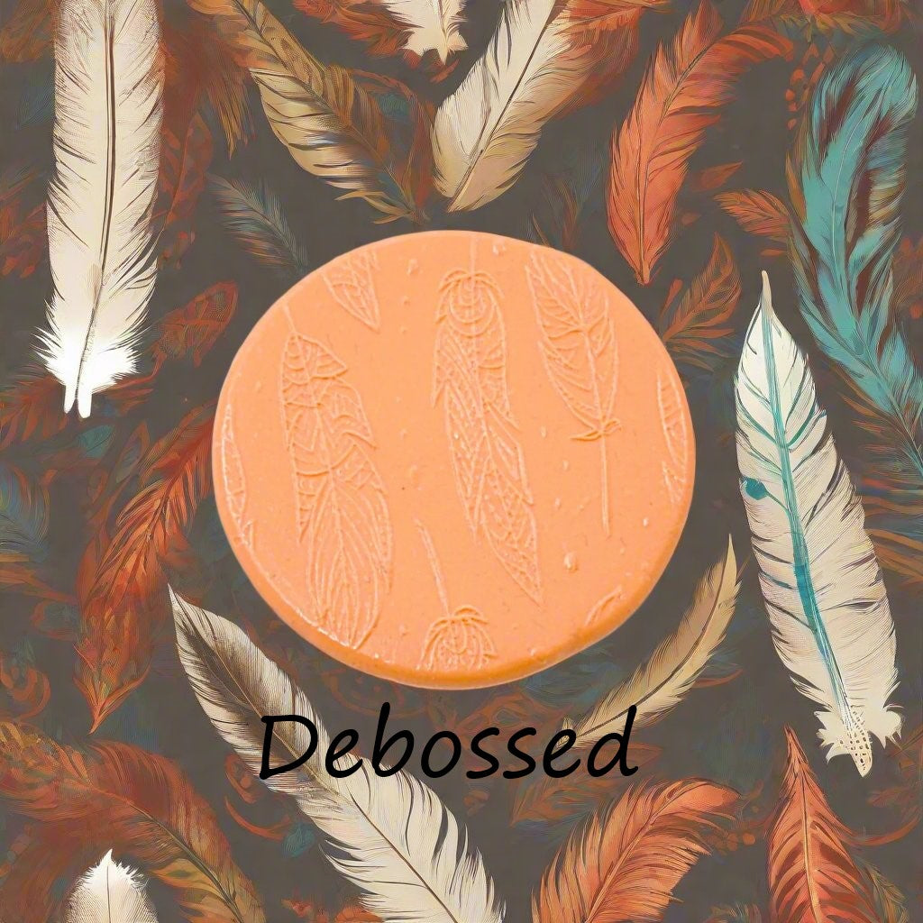 An intricate tribal feather pattern embossed in silly putty Using a patterned debossed texture mat in grey material. This will give you an idea of what it will look like on metal clay or polymer clay.