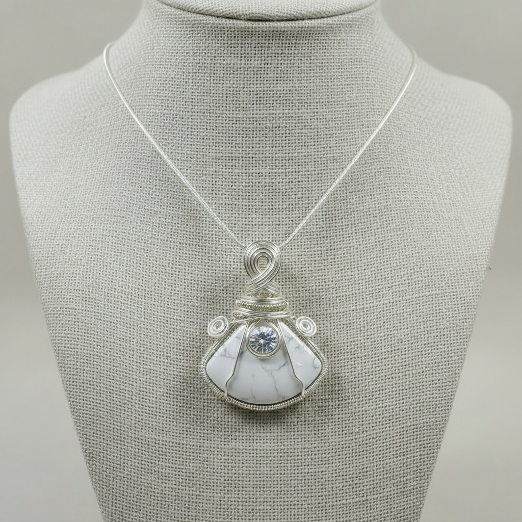Necklace with a white stone pendant on a mannequin bust against a gray background