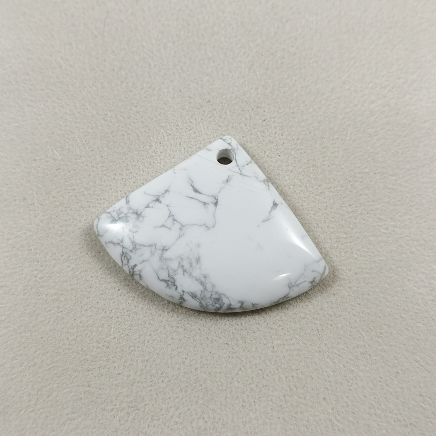 Marble-patterned stone pendant on a beige background