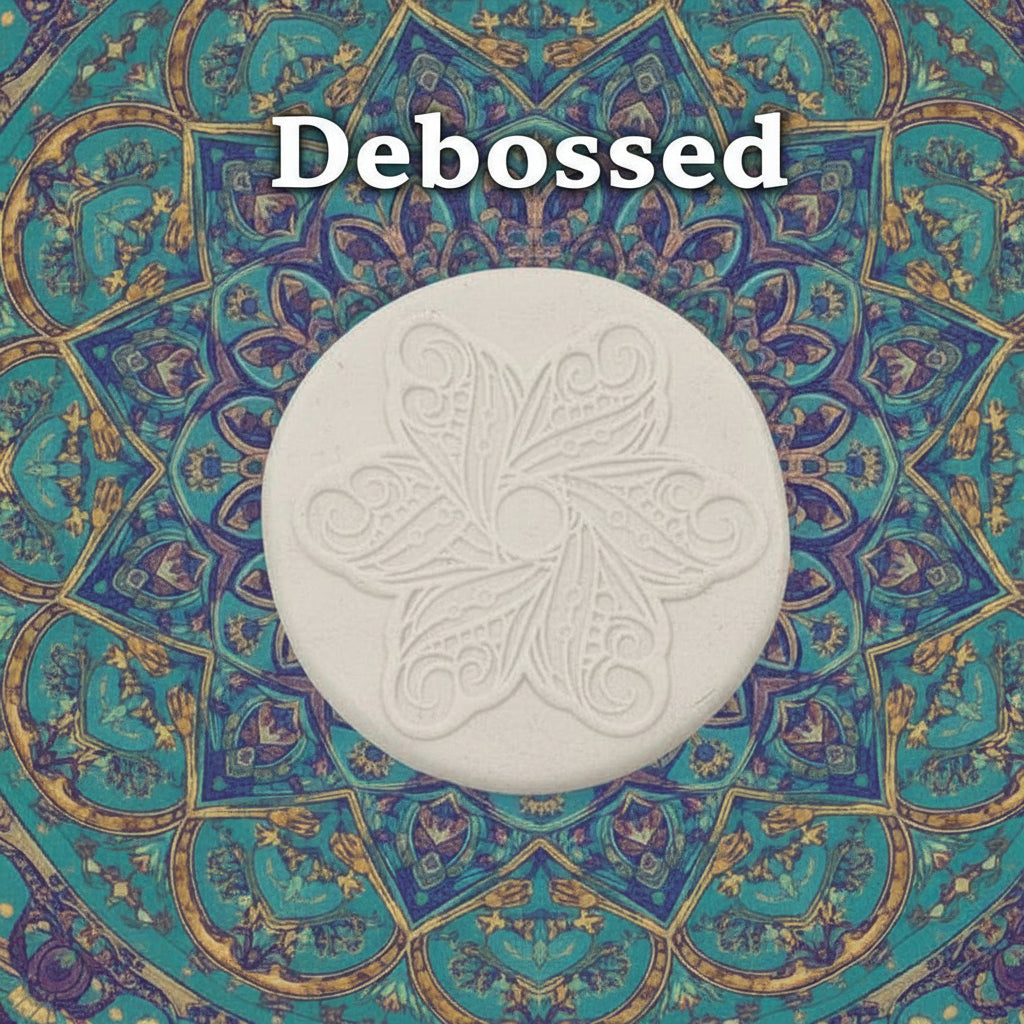 A flower mandala embossed in clay using a debossed texture mat. 