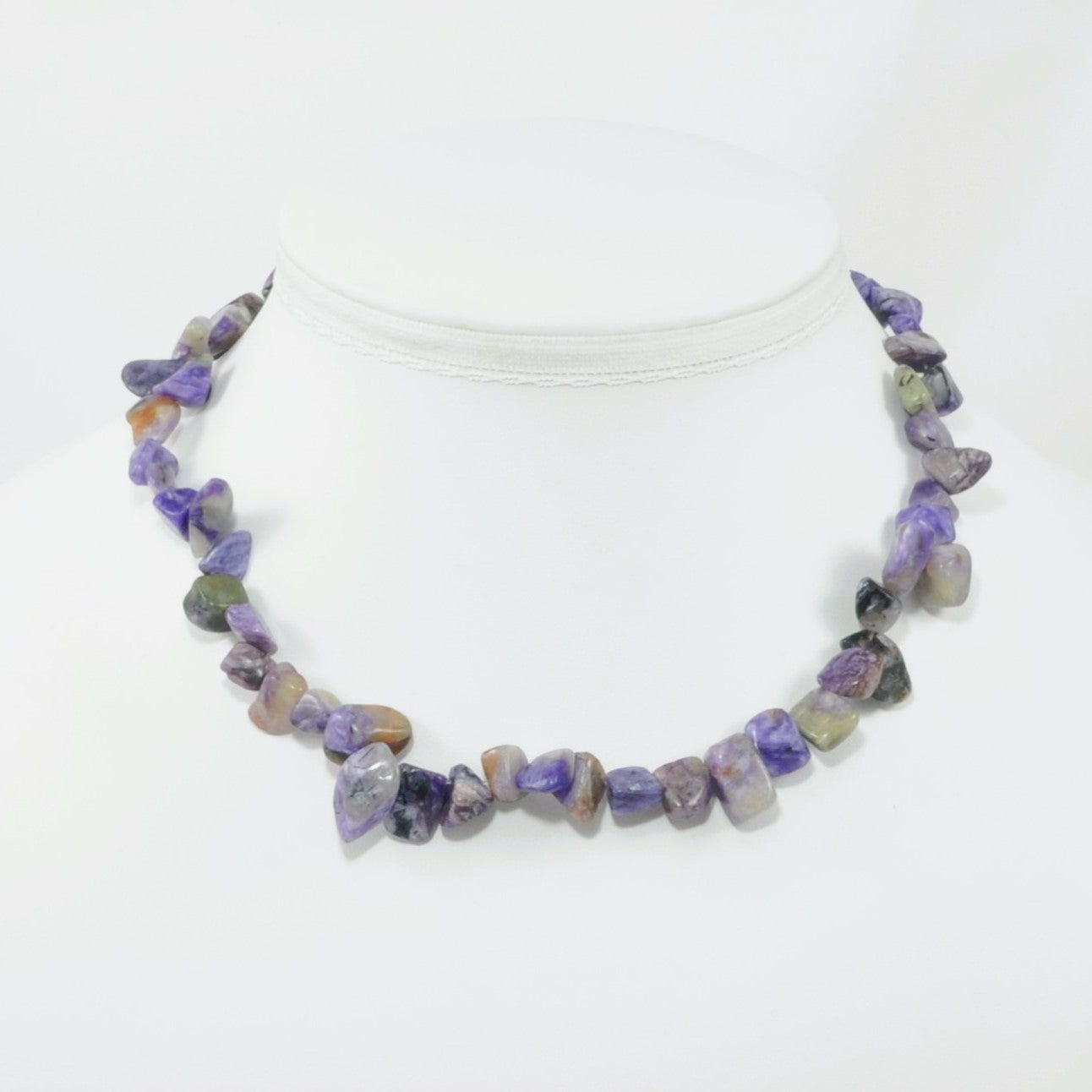 Necklace with purple and brown beads on a white background