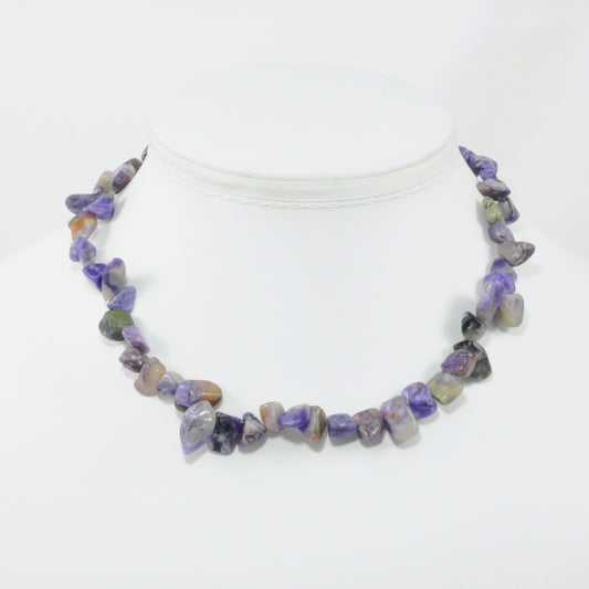 Necklace with purple and brown beads on a white background