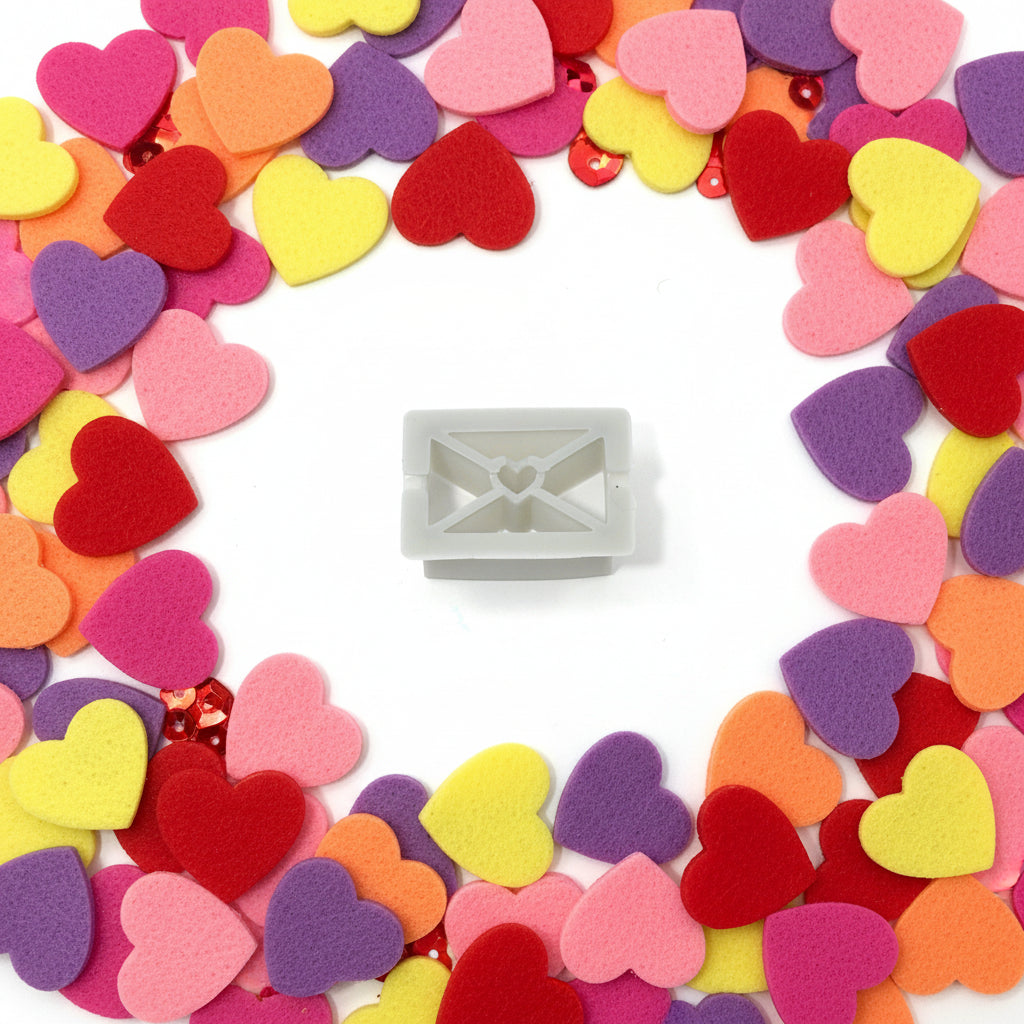 Colourful heart-shaped confetti with a small rectangular object in the centre on a white background