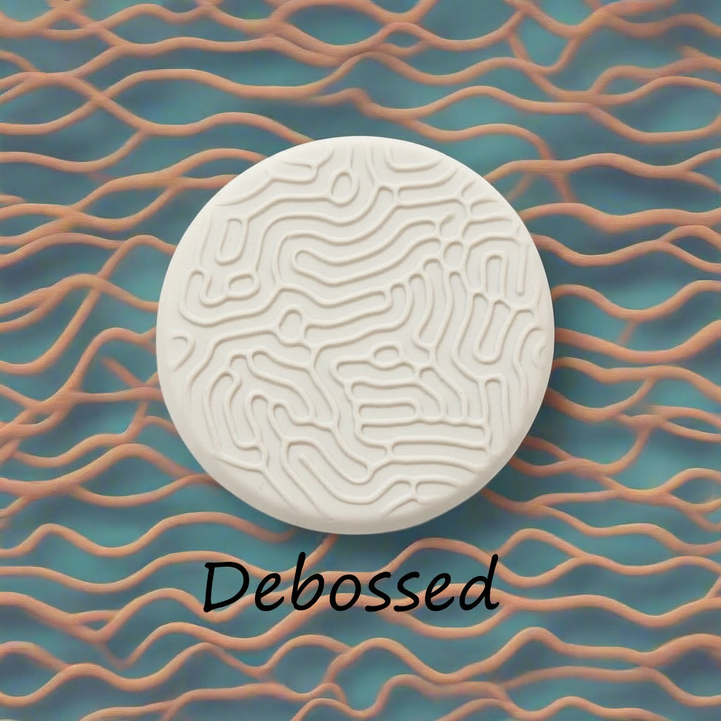 A pattern embossed in clay using a patterned debossed texture mat.