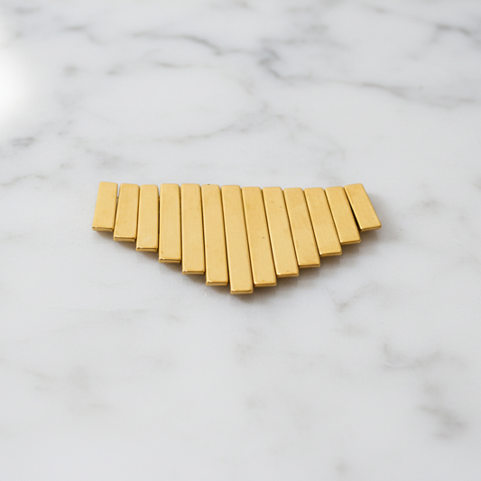 "Metallic gold graduated fan beads 20-13mm set of 13 pieces showing Art Deco style pendant beads arranged in descending size order"