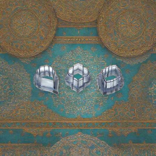 Three clear resin cutters displayed against an ornate Moroccan-style background with golden and turquoise patterns.