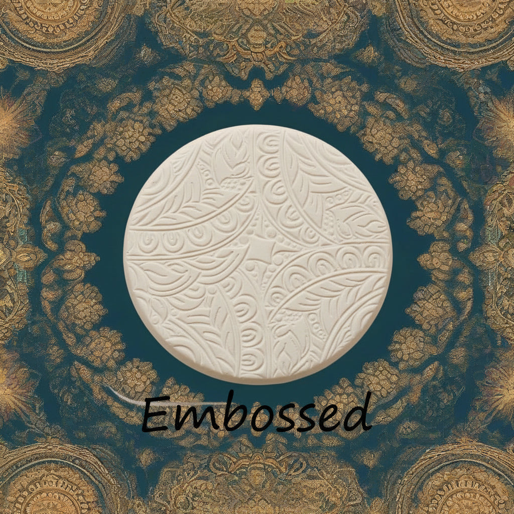 A flowery design debossed in clay Using a  embossed texture mat. This will give you an idea of what it will look like on metal clay or polymer clay.