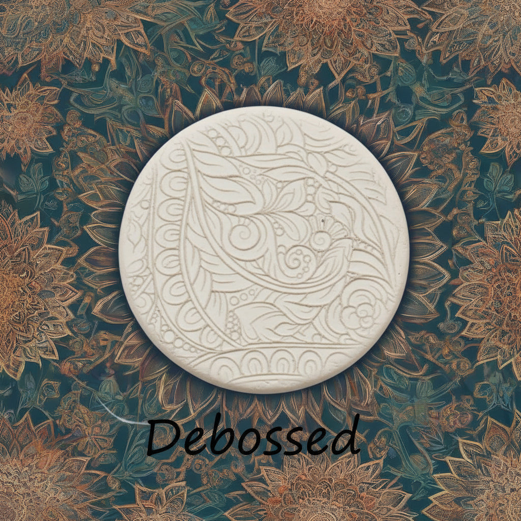 A flowery design embossed in clay Using a  debossed texture mat. This will give you an idea of what it will look like on metal clay or polymer clay.