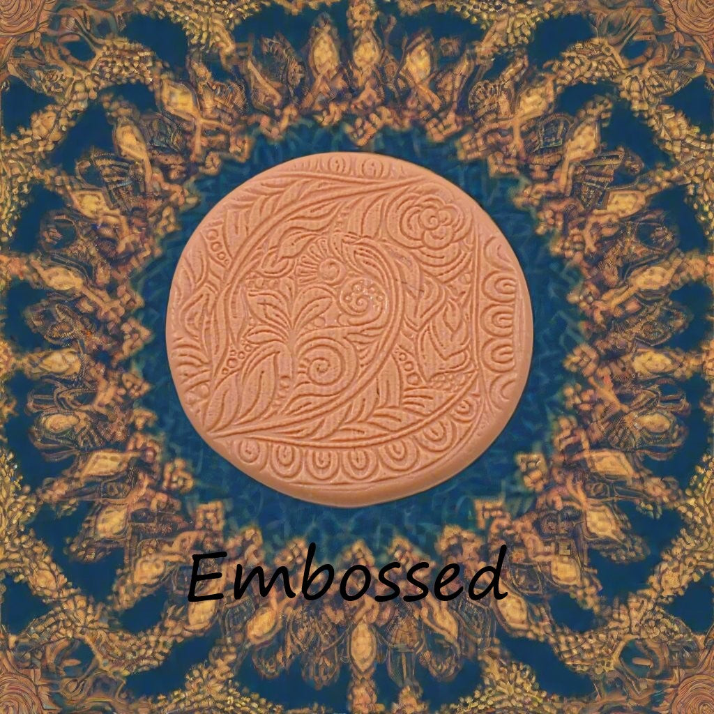 A flowery design debossed in silly putty Using a embossed texture mat. This will give you an idea of what it will look like on metal clay or polymer clay.
