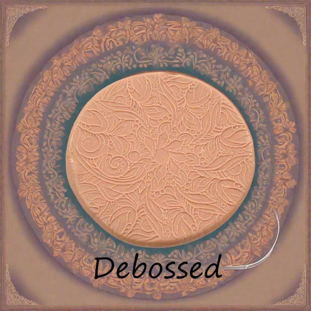 A flowery design embossed in silly putty using a  debossed texture mat. This will give you an idea of what it will look like on metal clay or polymer clay.