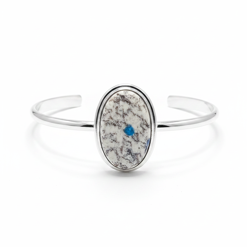 Silver bracelet with a textured stone inset on a white background